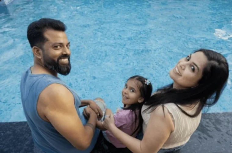 A family in the swimming pool at Nandi Brindavan